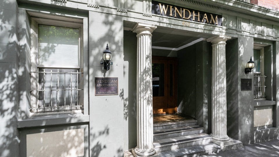 the facade of a building with columns and a sign that reads windham