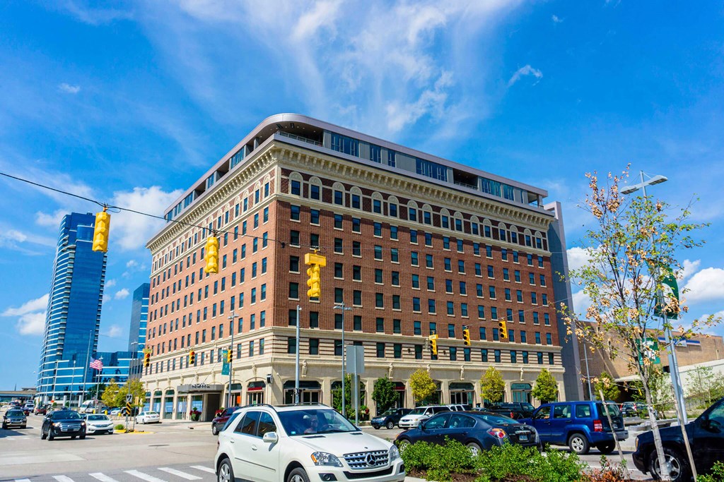 a large brick building with cars parked in front of it at The Rowe, Grand Rapids, Michigan