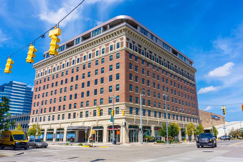 a large brick building with a traffic light in front of it at The Rowe, Grand Rapids, MI