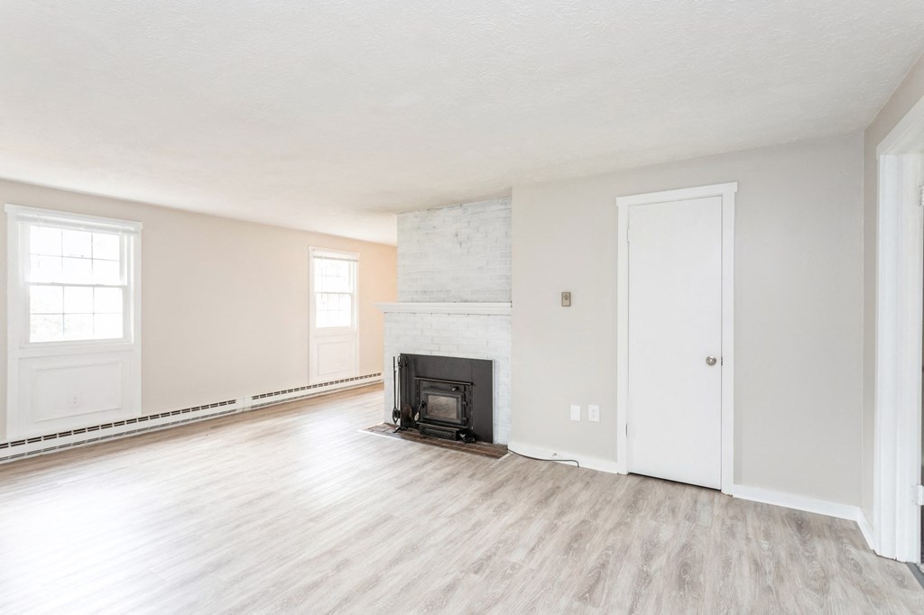 an empty living room with a fireplace at Stonebridge, Connecticut