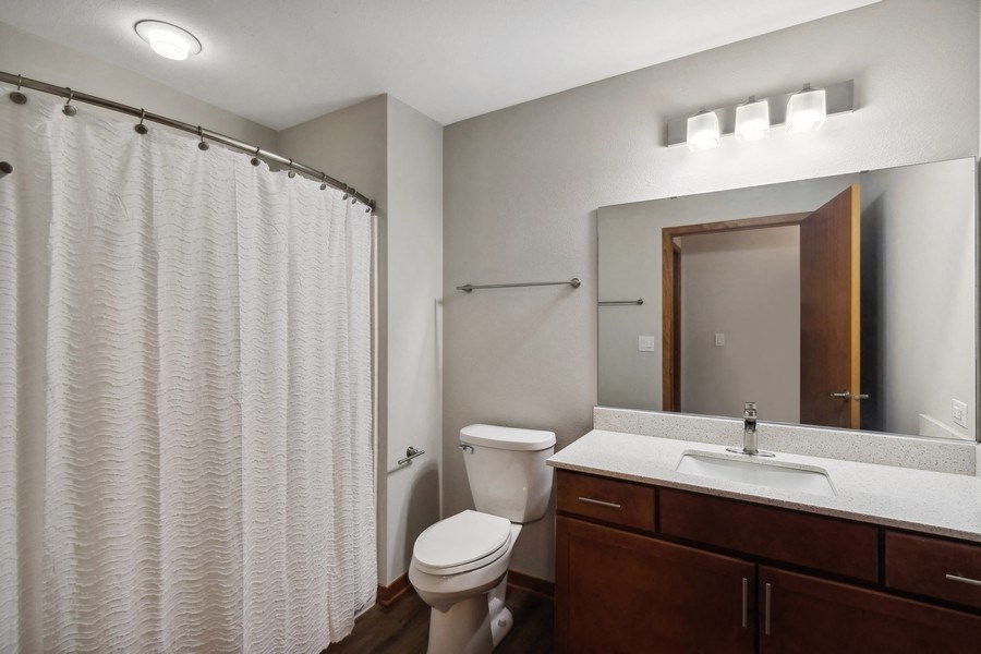 a bathroom with a toilet and a sink and a mirror