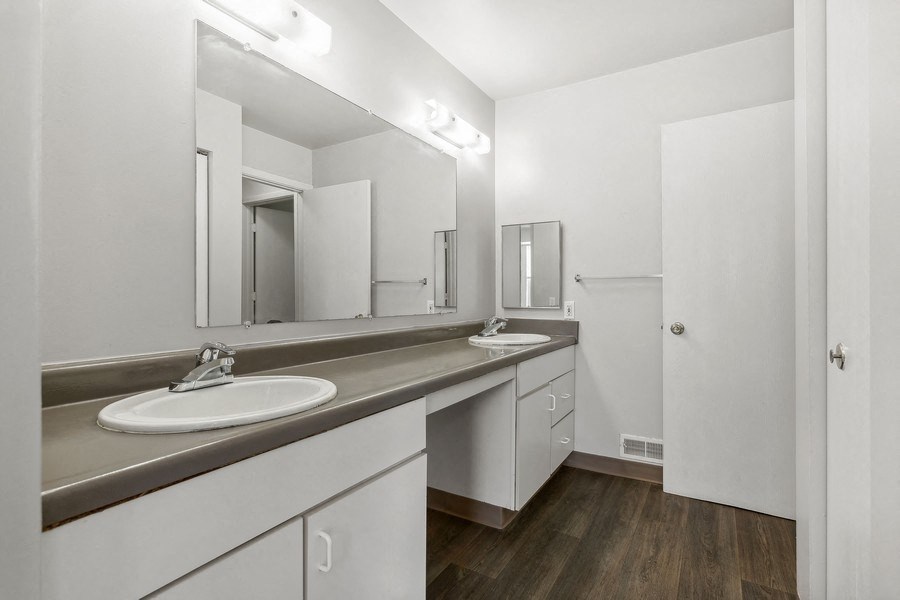 a bathroom with two sinks and a mirror at Mason Street Townhomes, Grand Rapids, 49505
