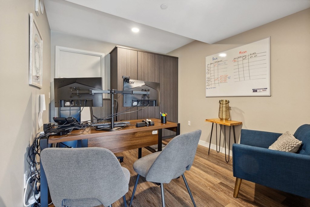 an office with a desk and chairs and a whiteboard at The Rowe, Michigan