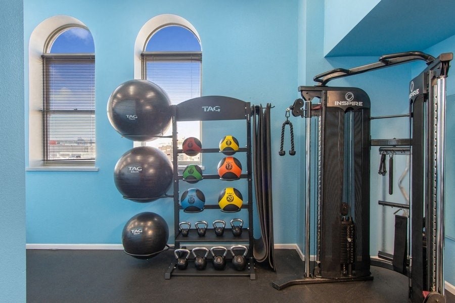 a blue wall with a fitness equipment in a fitness center