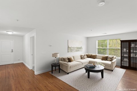 A living room with a white couch and a coffee table.