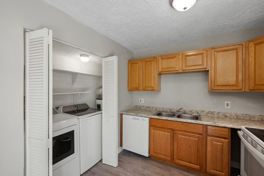a kitchen with white appliances and wooden cabinets at Fort Collier Terrace, Winchester, 22601