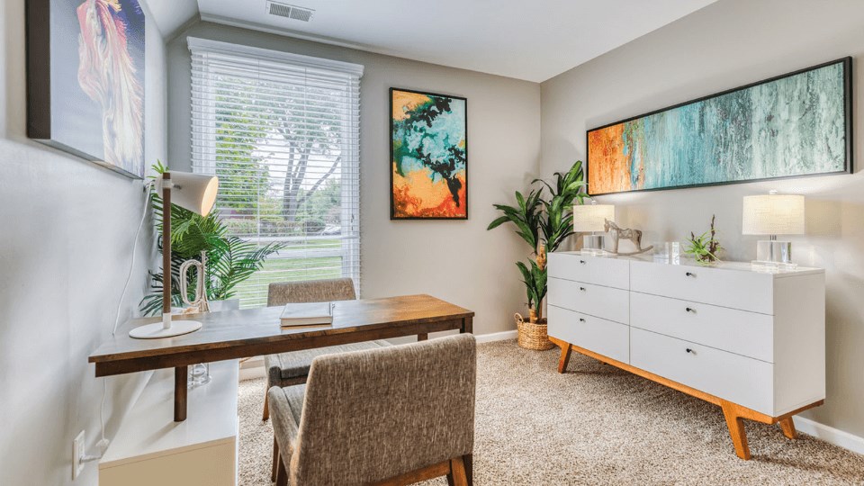 a home office with a desk and a dresser at The View Apartments St Charles, St Charles, IL