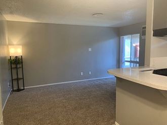 an empty room with a table and a lamp an empty room with a table and a lamp at Dwell Apartment Homes, Riverside, CA, 92507
