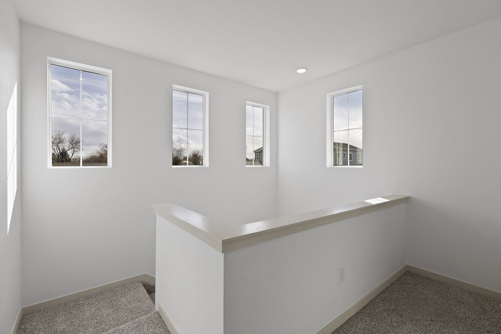 a white room with four windows and a ledge on the wall at Arrive Longmont, Longmont