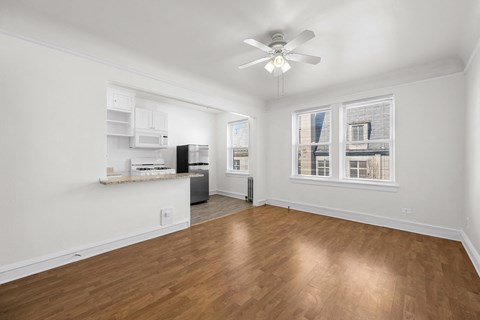A room with a ceiling fan and wooden flooring at Pleasant Oak Apartments, Oak Park, IL