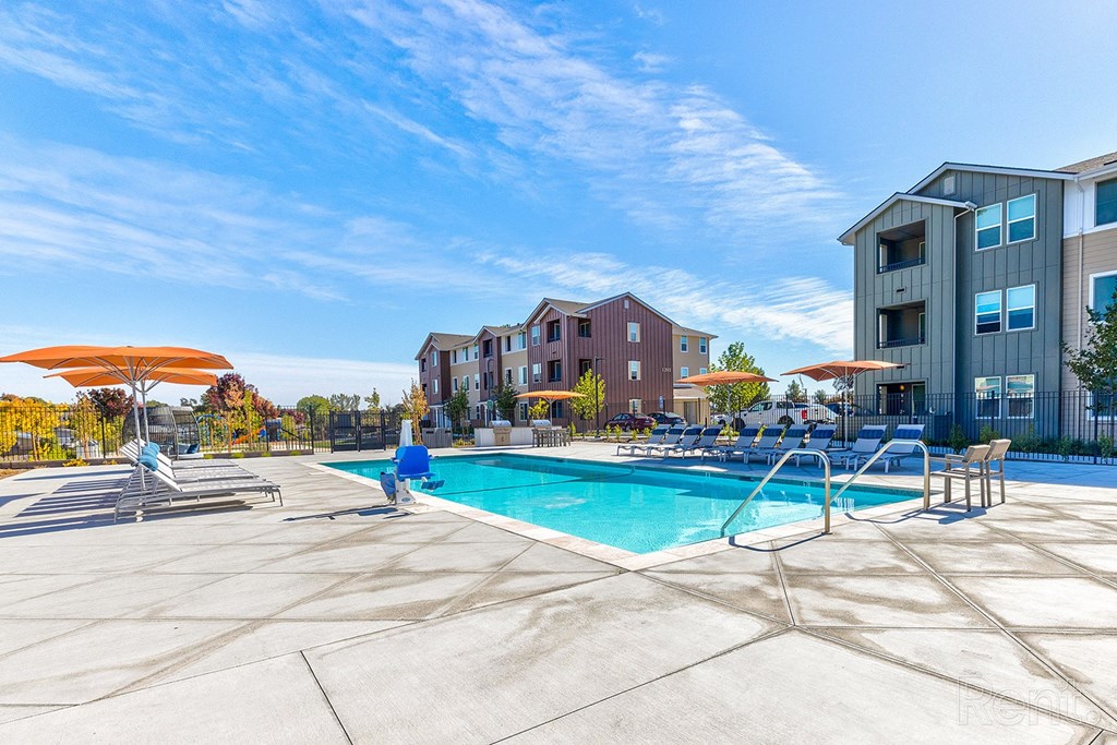 A swimming pool surrounded by apartment buildings.