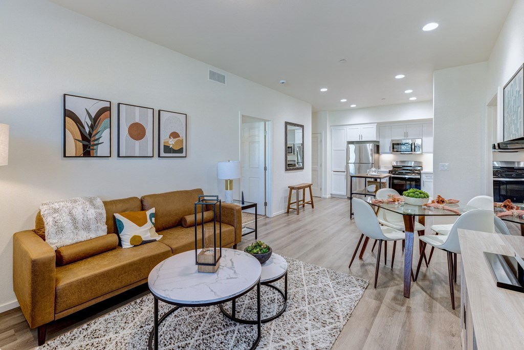 A living room with a brown couch and a coffee table.