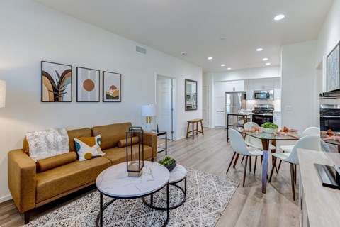 A living room with a brown couch and a coffee table.