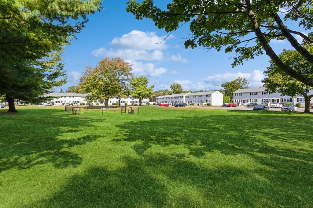 a park with green grass and the apartment buildings in the background at Fox Hill Commons, Vernon, CT, 06066