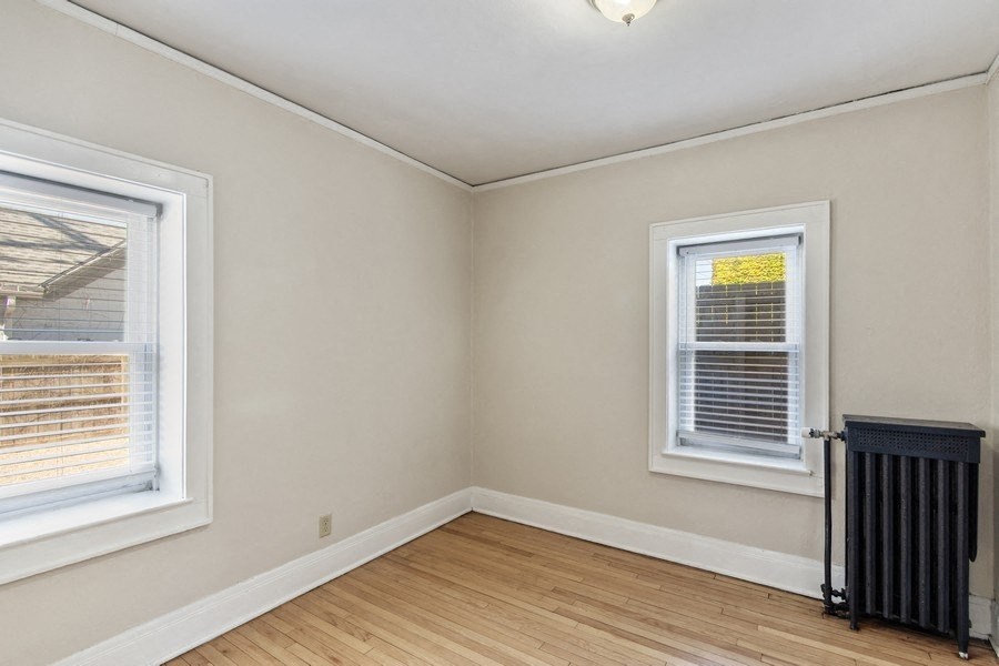 the living room  with two windows and a radiator