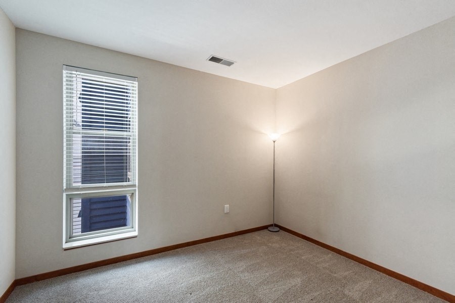 an bedroom with a window and a lamp