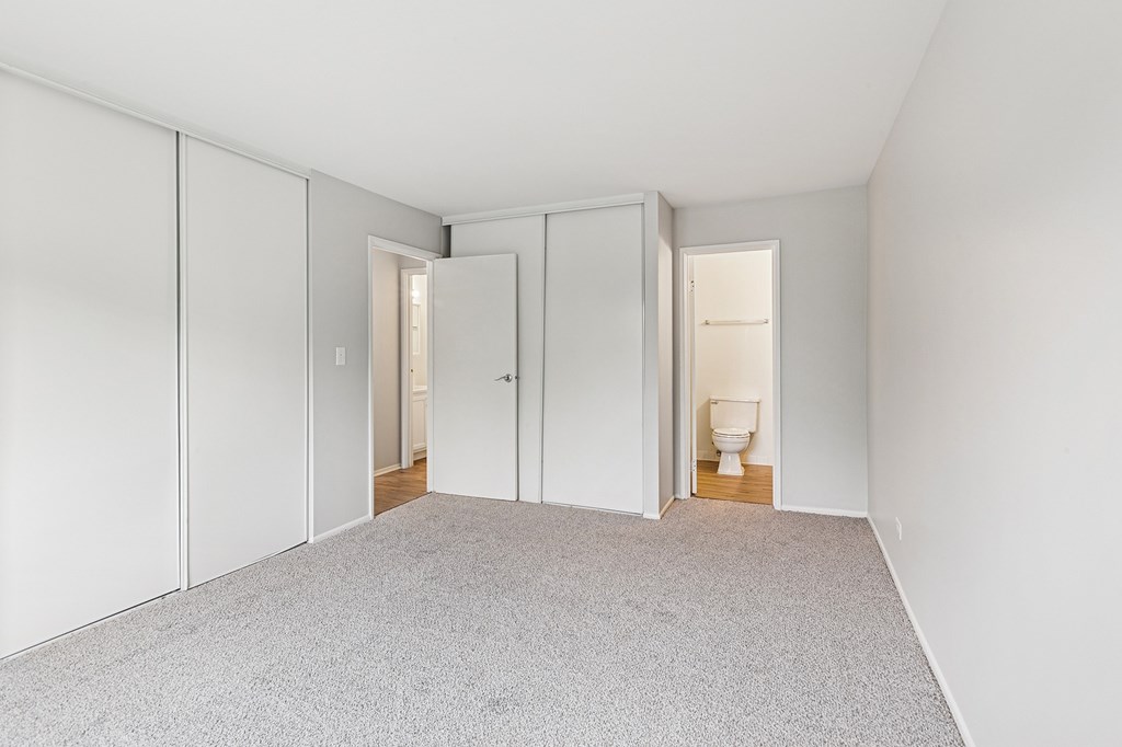 Bedroom with white walls with two doors