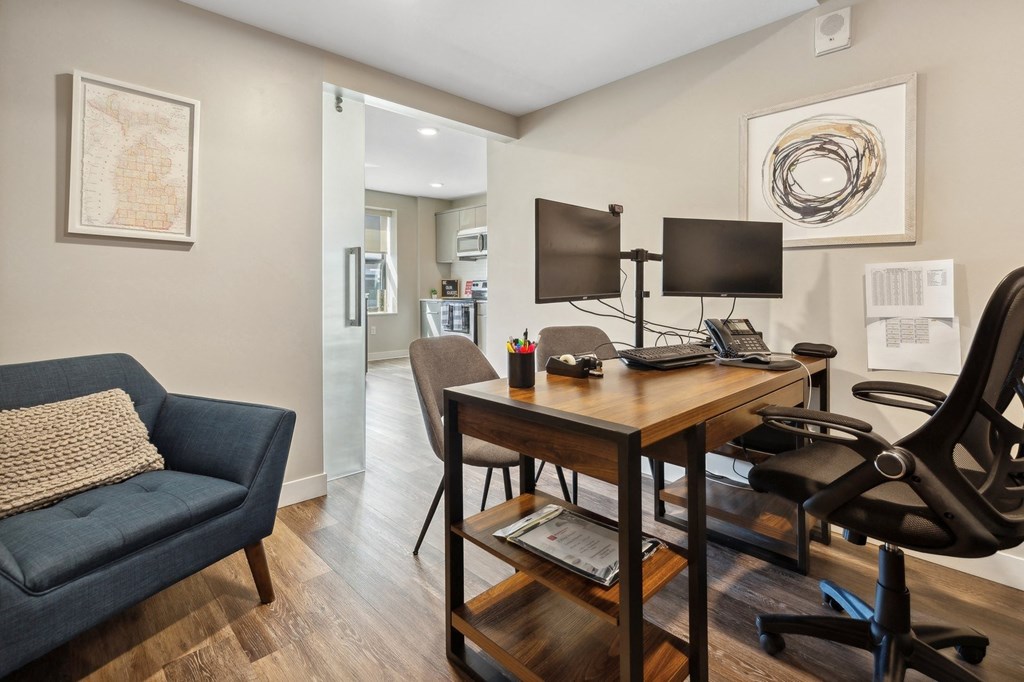 a home office with a desk and two monitors at The Rowe, Grand Rapids