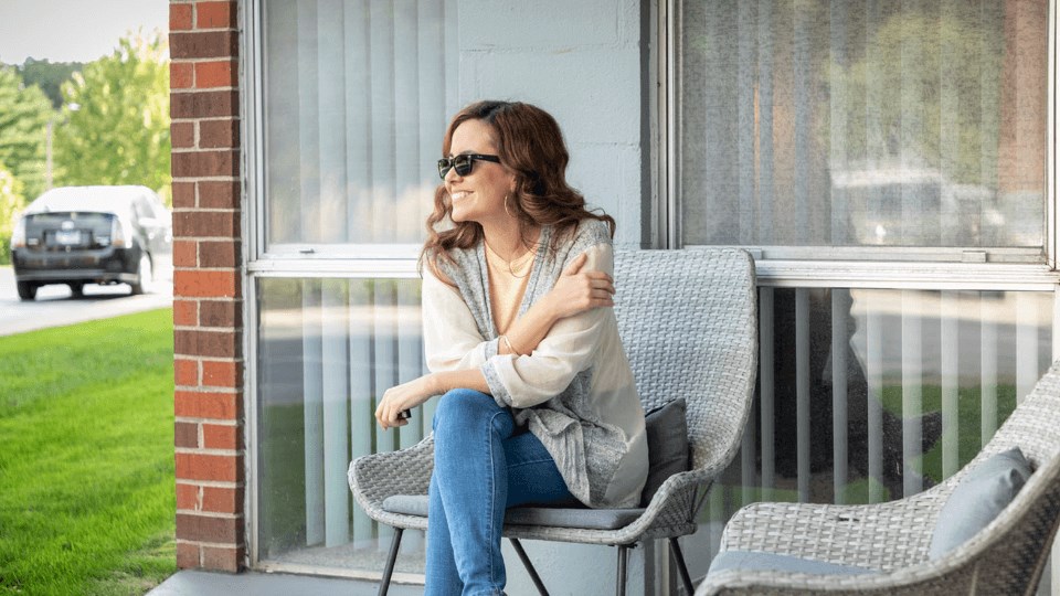 a woman sitting on a chair on a porch at St. Charles, St. Charles, IL, 60174