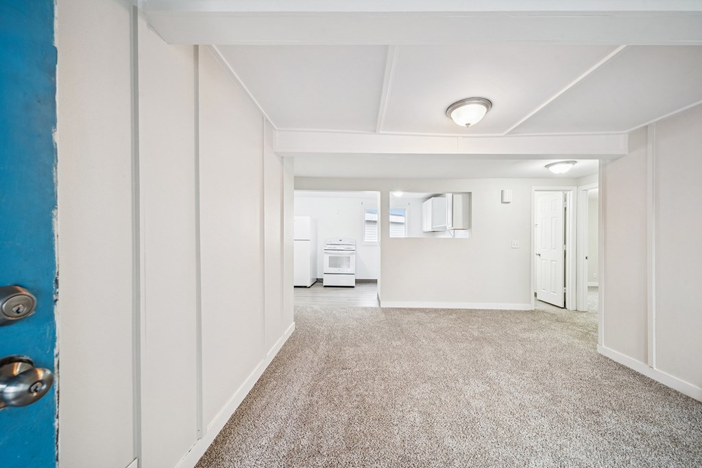 A room with a blue door and white walls.