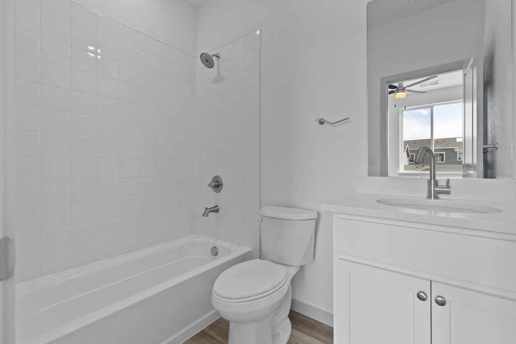 a bathroom with a toilet and a tub and a sink at Arrive Longmont, Longmont, CO