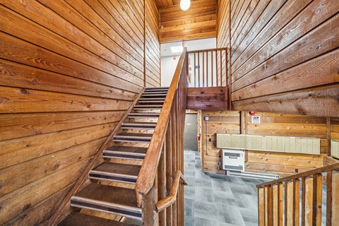 A wooden staircase in an apartment complex.
