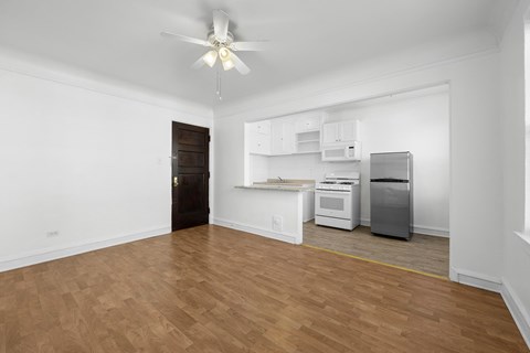 A room with a ceiling fan and a kitchenette at Pleasant Oak Apartments, Oak Park