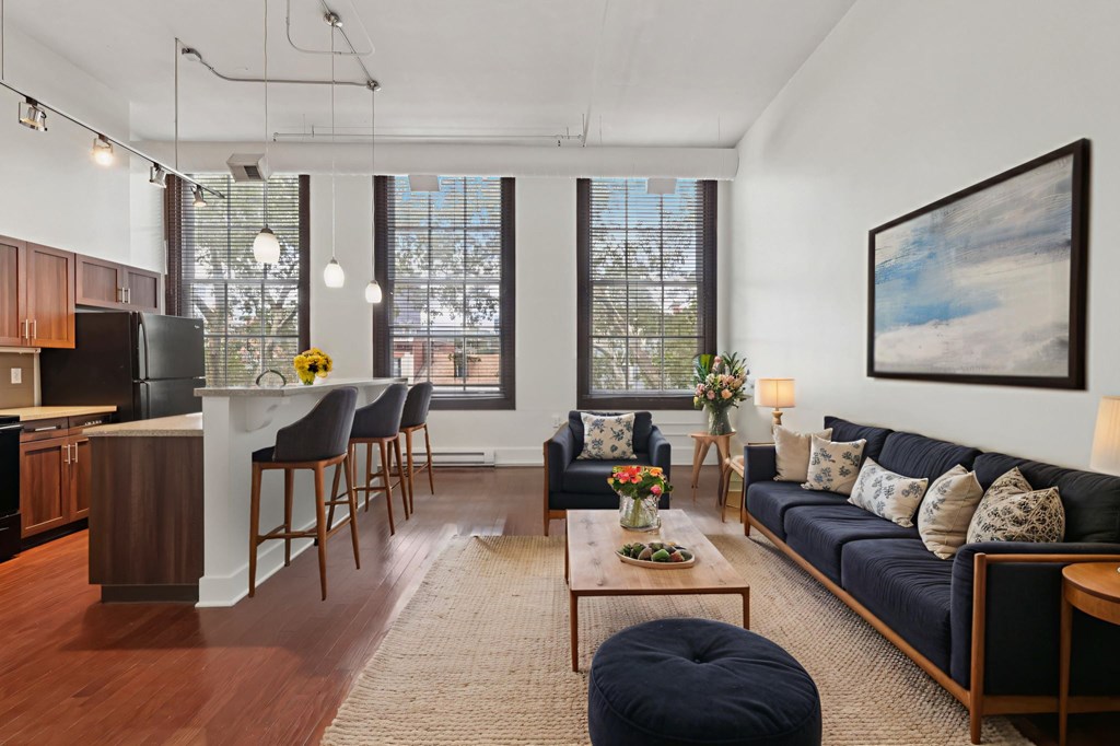 A living room with a blue couch and a coffee table.