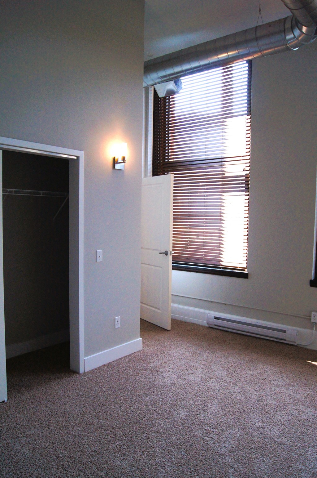 an empty room with a window and a door