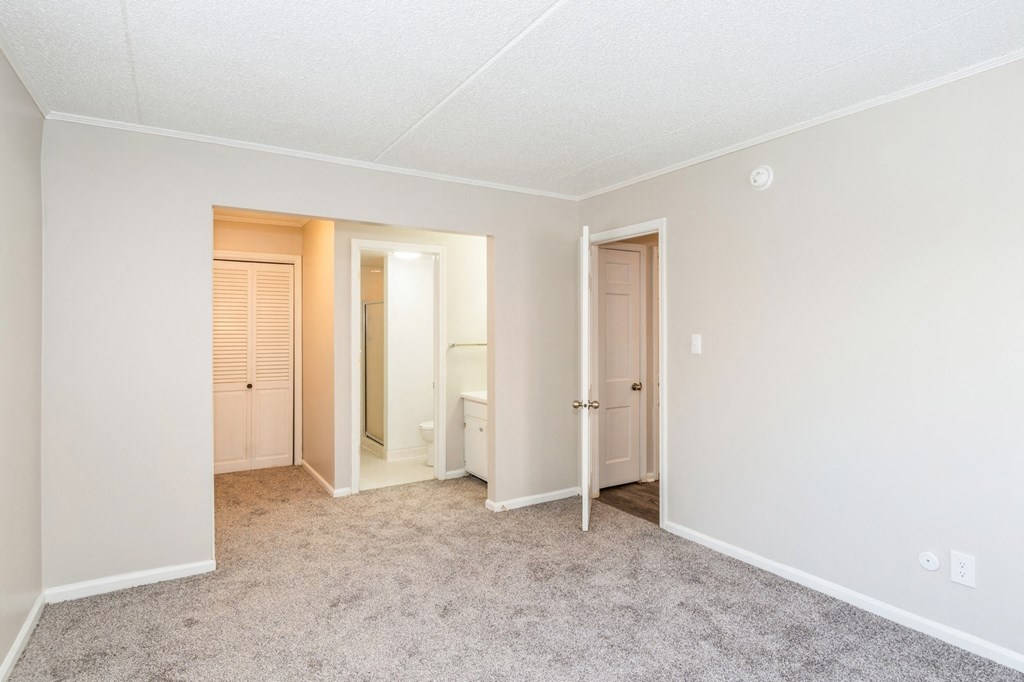 A room with a carpeted floor and white walls.