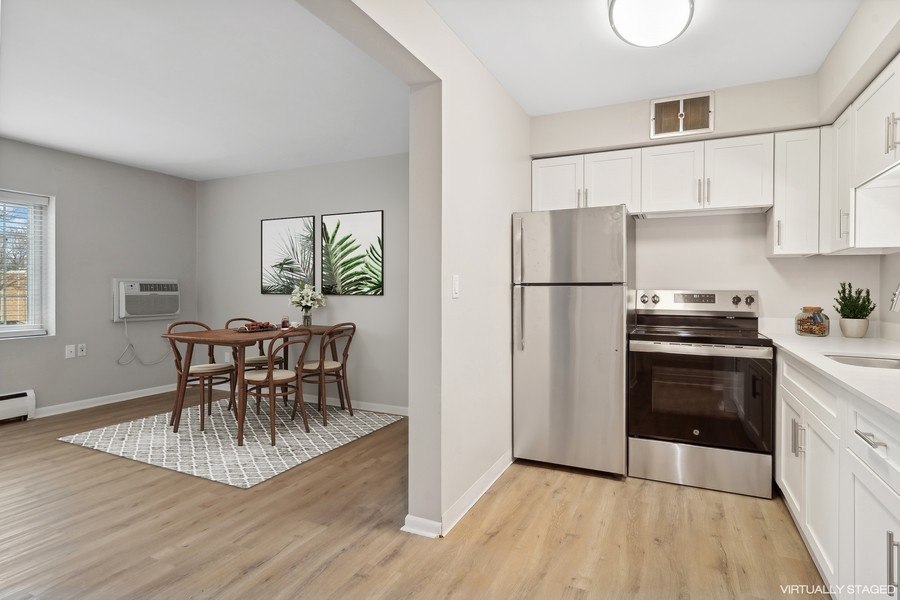 A kitchen with a table and chairs in the middle of the room.