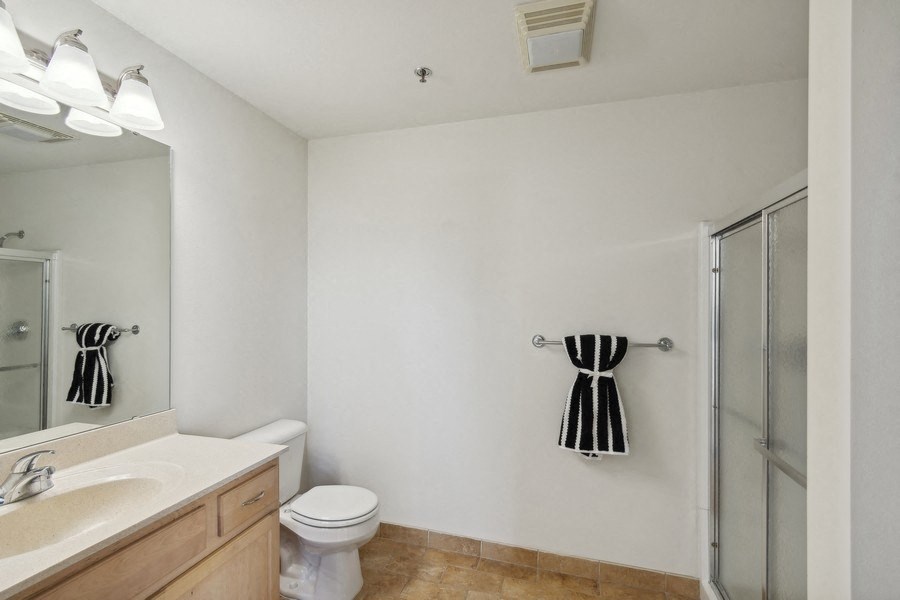 a bathroom with a sink toilet and a walk in shower