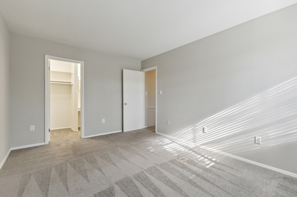 the living room of an apartment with white walls and carpet at Briarwood Apartments, Dumfries, 22026