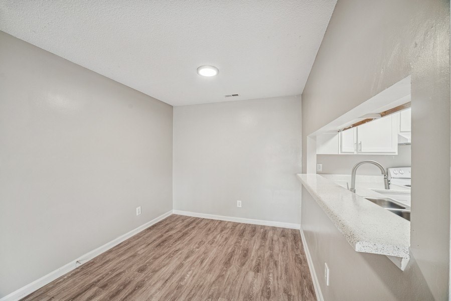 A room with a wooden floor and white walls.
