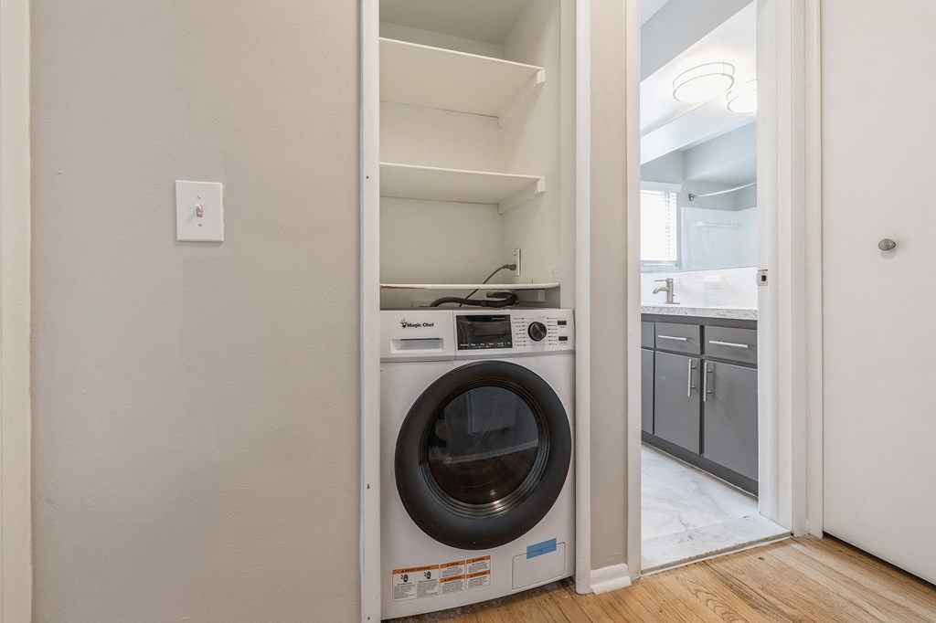 an empty laundry room with a washer and dryer in it