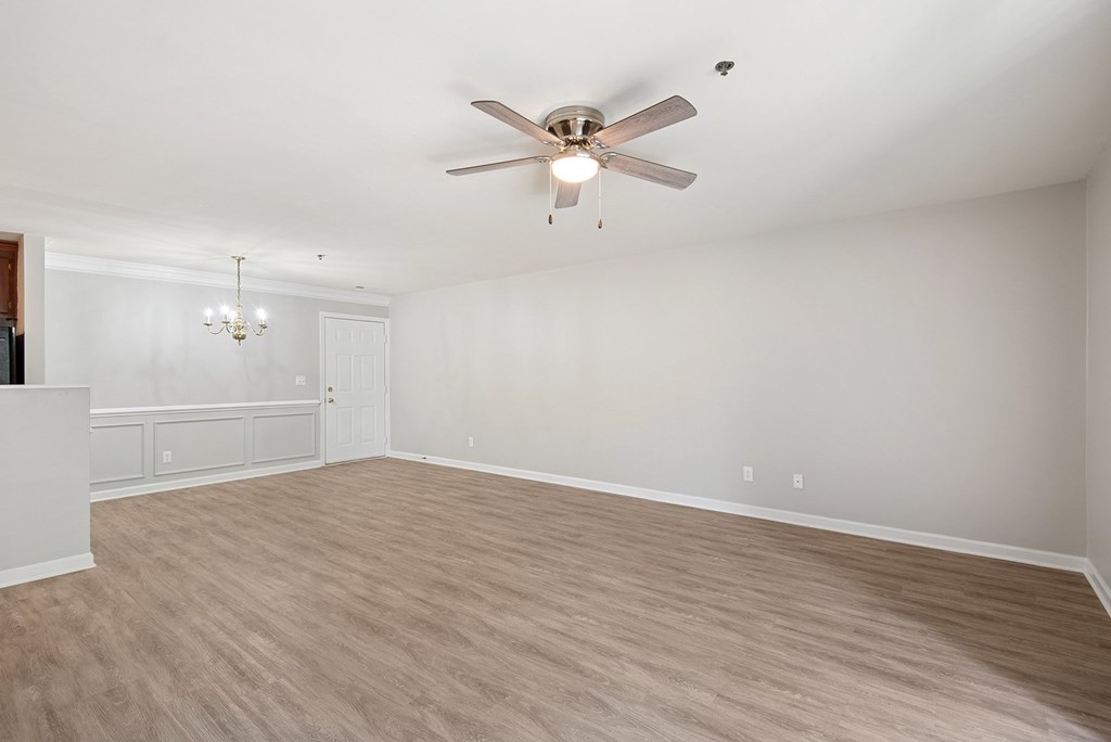 A room with a ceiling fan and light fixture.