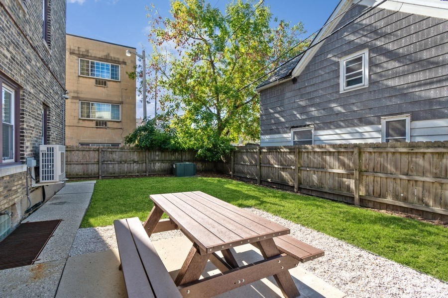 the backyard with a picnic table and a privacy fence