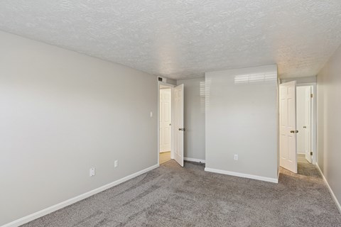 A room with carpeted floor and white walls.