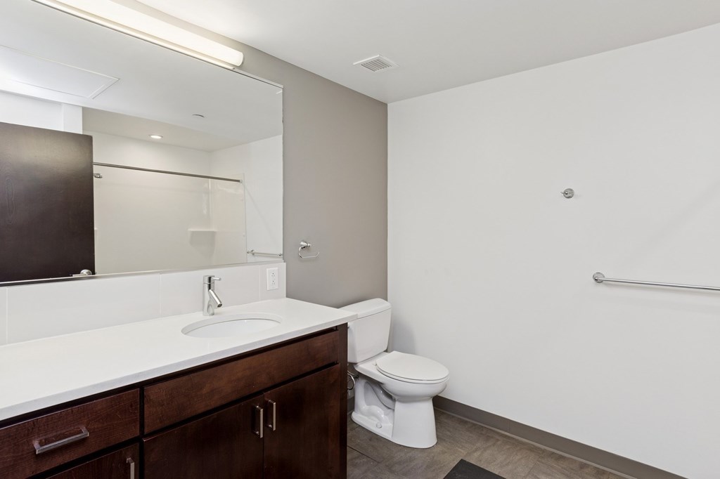 A white sink is in a bathroom with a toilet and a shower.