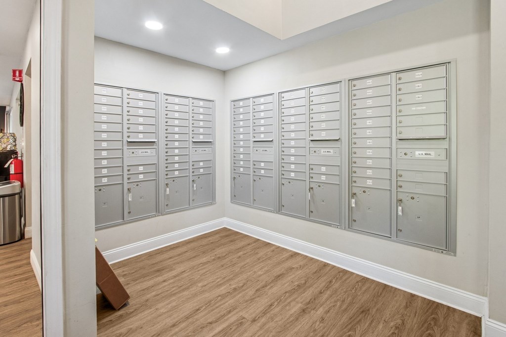 A room with a long row of mailboxes on the wall.