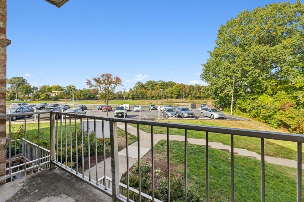 the view of the parking lot from the balcony of a building with a metal railing at Briarwood Apartments, Dumfries