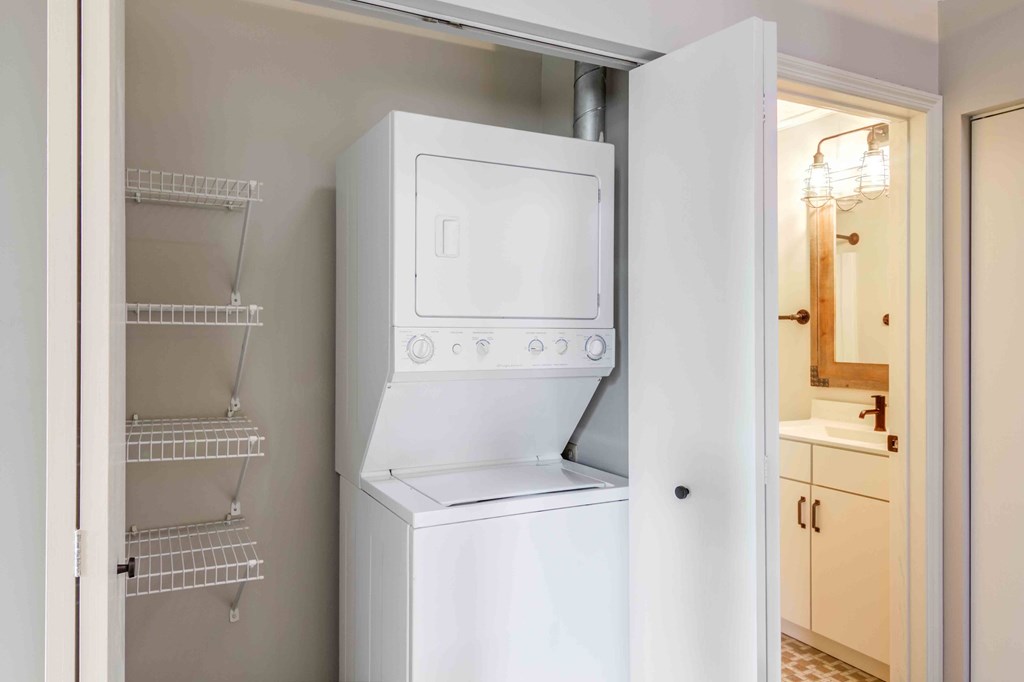 A white refrigerator with its door open in a kitchen.
