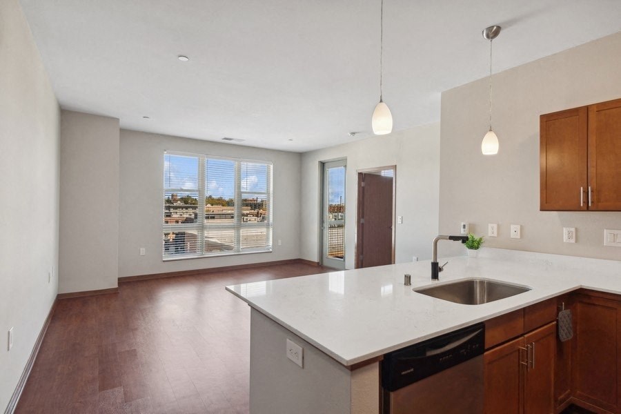a large kitchen with a sink and a large window