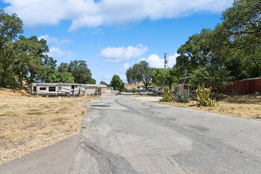A road with a sidewalk and trees on both sides.