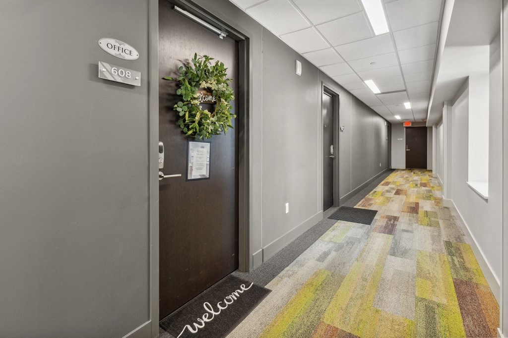 a hallway of elevators and doors in an office building at The Rowe, Michigan
