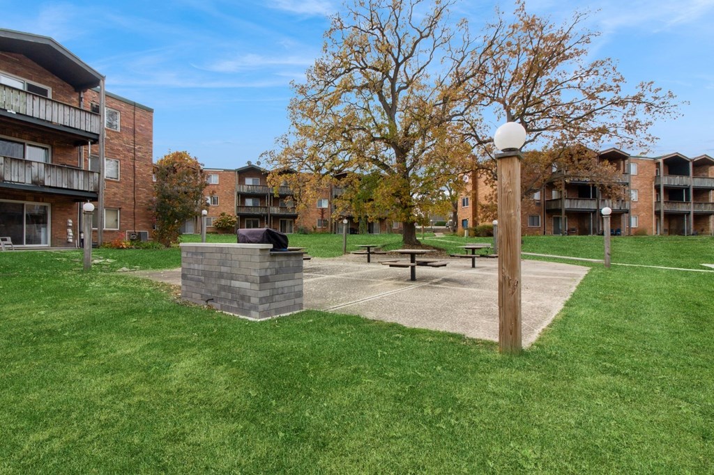our apartments have a park with a picnic table and a fire pit at River Oaks, North Aurora, Illinois