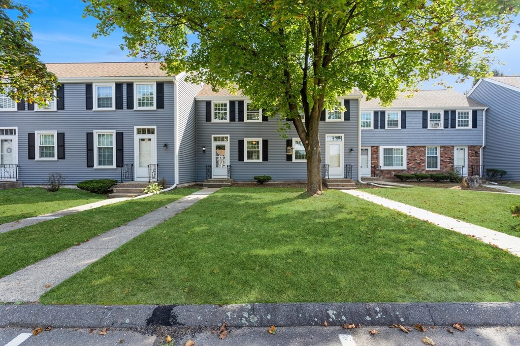 Front of apartments with sidewalks and landscape at Arbor Commons.