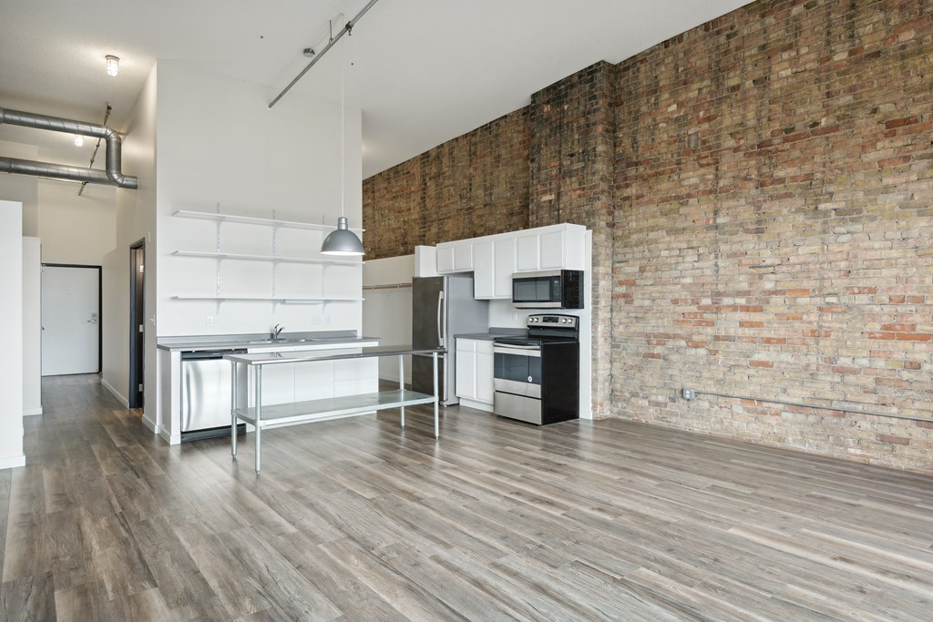a kitchen and dining area in a 555 waverly unit at Gaar Scott Historic Lofts, Minneapolis, Minnesota