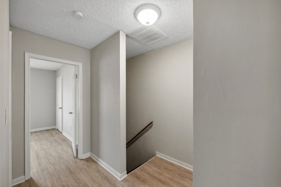 a hallway with wood floors and grey walls at Fort Collier Terrace, Virginia, 22601