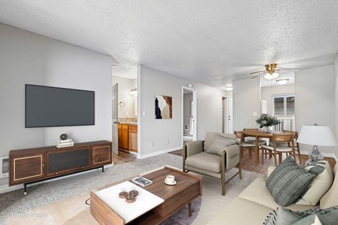 A living room with a flat screen TV and a wooden cabinet.